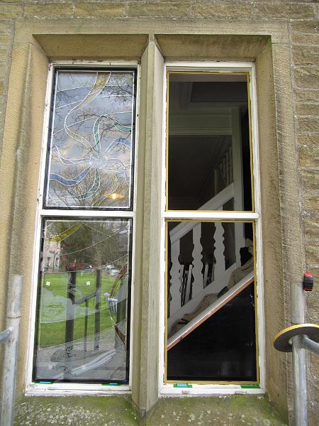 first_two.JPG - That is the first two  lights  in place - you can see here how the stairs cut across the window. Jackie took this into account when designing the window; using a mixture of stained and uncoloured sanded blasted areas, so that the design would show to optimum effect when viewed under different lighting from both inside and outside the hall.