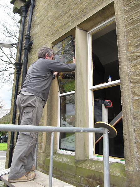 fitting_upper_light.JPG - Alec Faraday installing the stained glass lights, which are sealed inside double glazed units.